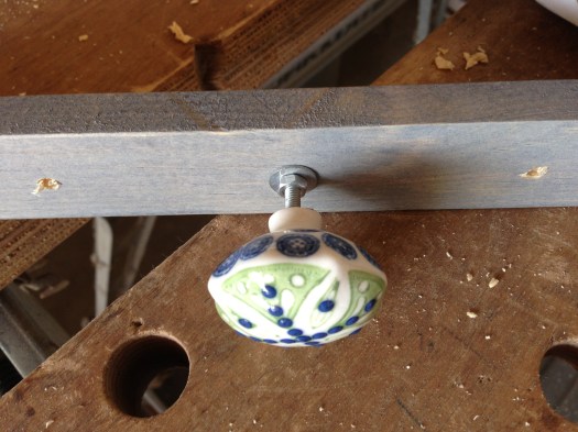 The front should have some space between the knob and the wood. You want to have this gap so that a few necklaces can hang on each knob.