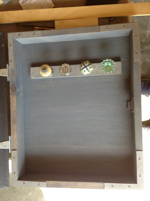 Once the stip of knobs is done, I secured it to the box from the back. Make sure the screws are flush with the back of the box!