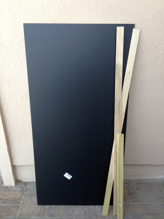 Finished chalkboard MDF and some poplar hobby wood. Approx. $15-$20 at Home Depot