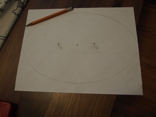 With a skinny shelf, the TV needed to be anchored to the wood to prevent falling (something earthquake-prone California needs to worry about). I used a piece of paper to make a template of the TV base.