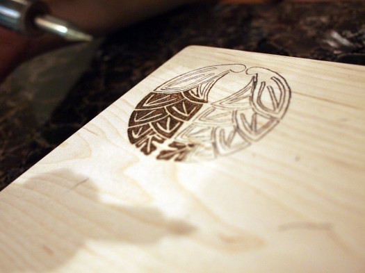 First you draw your design onto the wood using the transfer paper, then go over it with the pyrography pen.