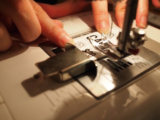 Fara graciously offered to help make tags. We ran them through a sewing machine to perforate them.