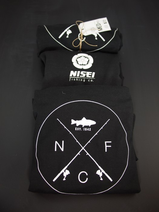 Limited run shirts I designed for the show. This pic shows the chest graphic (bottom), back neckline graphic (center), and rolled/packaged shirt.